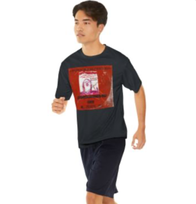 Person wearing a black t-shirt with a graphic design and dark shorts, walking.